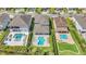 An aerial view showcases houses, each with a uniquely designed backyard and pool at 501 Burma St, Kissimmee, FL 34747