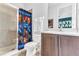 Bathroom featuring a tiled shower and a single sink vanity with a novelty Star Wars shower curtain at 501 Burma St, Kissimmee, FL 34747