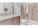 Bathroom features a single vanity with stone countertop and a glass-enclosed shower at 501 Burma St, Kissimmee, FL 34747