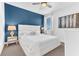 Bright bedroom features a king bed with blue accent wall, providing a relaxing retreat at 501 Burma St, Kissimmee, FL 34747