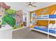 Fun bedroom with custom murals and bunk beds creates a playful and imaginative space at 501 Burma St, Kissimmee, FL 34747