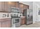 Kitchen featuring stainless steel appliances and dark wood cabinets at 501 Burma St, Kissimmee, FL 34747