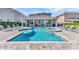 Beautiful outdoor swimming pool with a connected jacuzzi and lounge chairs on the patio at 501 Burma St, Kissimmee, FL 34747