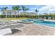 Well-maintained pool area with lounge chairs and manicured landscaping featuring tropical palm trees at 501 Burma St, Kissimmee, FL 34747