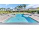 Refreshing swimming pool with an attached spa and lounge seating under a sunny sky at 501 Burma St, Kissimmee, FL 34747