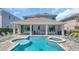 Relaxing backyard pool and patio area with a barbecue and ample seating for outdoor enjoyment at 501 Burma St, Kissimmee, FL 34747