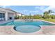 Gorgeous in-ground pool and spa surrounded by lounge chairs and a well-manicured backyard at 501 Burma St, Kissimmee, FL 34747