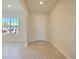 Bright foyer features tile flooring, a window with neighborhood views, and a white front door at 5074 Sparkling Water Way, Kissimmee, FL 34746