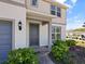 Close-up of front porch with manicured landscape and brick walkway leading to a gray front door at 5074 Sparkling Water Way, Kissimmee, FL 34746