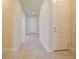 Inviting hallway featuring tile flooring and neutral tones, leading to various areas of the home at 5074 Sparkling Water Way, Kissimmee, FL 34746