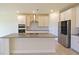 Modern kitchen with stainless steel appliances, a large island, and sleek gray countertops at 5074 Sparkling Water Way, Kissimmee, FL 34746