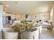 Bright living room with white sectional, decorative artwork, and modern glass dining table at 5074 Sparkling Water Way, Kissimmee, FL 34746