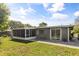 Home's backyard with patio and screen porch, providing a great outdoor living space at 520 Oriole Dr, Lakeland, FL 33803