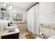 Bathroom featuring a double sink vanity with tiled backsplash, black fixtures, and a shower-tub combination at 520 Oriole Dr, Lakeland, FL 33803