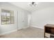 Bright, freshly painted bedroom with plush carpet and modern lighting at 520 Oriole Dr, Lakeland, FL 33803