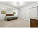 Cozy bedroom with a bed, carpet flooring, two windows, baseboard molding and ample closet space at 520 Oriole Dr, Lakeland, FL 33803