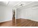 Bright bedroom featuring hardwood floors, a modern light fixture, and a neutral color palette at 520 Oriole Dr, Lakeland, FL 33803