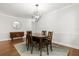 Dining room featuring hardwood floors, modern lighting fixture, and updated trim at 520 Oriole Dr, Lakeland, FL 33803