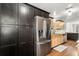 Kitchen featuring stainless steel appliances, light wood cabinets and dark cabinetry for additional storage at 520 Oriole Dr, Lakeland, FL 33803