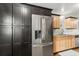 Kitchen featuring stainless steel appliances, light wood cabinets and dark cabinetry for additional storage at 520 Oriole Dr, Lakeland, FL 33803