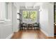 Bright living room featuring hardwood floors, natural light, and modern decor with seating and shelving at 520 Oriole Dr, Lakeland, FL 33803