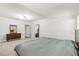 Spacious bedroom featuring a bed, carpet flooring, baseboard molding and a decorative mirror at 520 Oriole Dr, Lakeland, FL 33803