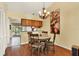 Dining area with hardwood floors, a chandelier, and access to the kitchen at 5429 Lake Margaret Dr # 185, Orlando, FL 32812