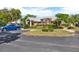 Community entrance with lush landscaping, manicured bushes and parking nearby at 5429 Lake Margaret Dr # 185, Orlando, FL 32812