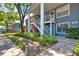 Landscaped condo building featuring staircases, foliage, and blue siding at 5429 Lake Margaret Dr # 185, Orlando, FL 32812