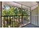 View of the screened patio with green foliage outside at 5429 Lake Margaret Dr # 185, Orlando, FL 32812