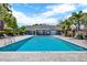 Sparkling community pool with clear blue water, surrounded by lounge chairs and tropical greenery at 5429 Lake Margaret Dr # 185, Orlando, FL 32812