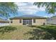 View of house with solar panels and screened patio, from the spacious backyard at 5832 Tarleton Way, Mount Dora, FL 32757