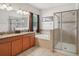 Bathroom featuring a double vanity, soaking tub, and glass-enclosed shower at 5832 Tarleton Way, Mount Dora, FL 32757
