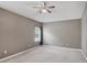Spacious bedroom featuring a ceiling fan and natural light from a window at 5832 Tarleton Way, Mount Dora, FL 32757