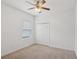 A bright bedroom with a ceiling fan and a closet provides a comfortable space at 5832 Tarleton Way, Mount Dora, FL 32757