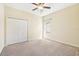 Clean bedroom featuring a large closet, window, and neutral carpet at 5832 Tarleton Way, Mount Dora, FL 32757