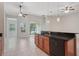 Open kitchen with a breakfast bar, wood cabinets, and a view to the sliding glass door at 5832 Tarleton Way, Mount Dora, FL 32757