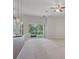 Bright living room featuring sliding glass doors to the backyard and modern pendant lighting above the breakfast bar at 5832 Tarleton Way, Mount Dora, FL 32757