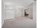 Spacious living room with neutral carpeting, complemented by a view of the kitchen at 5832 Tarleton Way, Mount Dora, FL 32757
