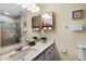 Bathroom featuring a shower, a white sink, and stylish medicine cabinets with a view of the toilet at 631 Reserve Dr, Davenport, FL 33896