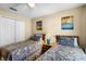 Bedroom featuring two twin beds, hardwood floors, a closet and stylish wall art at 631 Reserve Dr, Davenport, FL 33896