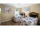 Bedroom featuring two twin beds, hardwood floors, a window with blinds and stylish wall art at 631 Reserve Dr, Davenport, FL 33896