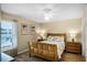 Serene bedroom with queen bed, side tables, ceiling fan and artwork on the walls at 631 Reserve Dr, Davenport, FL 33896