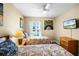 Bedroom featuring two twin beds, hardwood floors, a window with blinds and colorful wall art at 631 Reserve Dr, Davenport, FL 33896