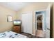 Bedroom featuring a bed, hardwood floors, a closet, a TV and an ensuite bathroom entrance at 631 Reserve Dr, Davenport, FL 33896