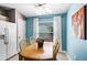 Bright dining area features natural light, neutral walls, wood table, and modern ceiling fan at 631 Reserve Dr, Davenport, FL 33896