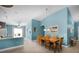 Bright and airy dining area features neutral walls, wood-look tile floors, and modern light fixture at 631 Reserve Dr, Davenport, FL 33896