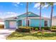 Charming, colorful single-story home with a well-manicured lawn and tropical landscaping at 631 Reserve Dr, Davenport, FL 33896