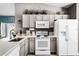 Well-lit kitchen featuring neutral countertops, cabinets, and modern appliances at 631 Reserve Dr, Davenport, FL 33896