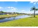 Scenic view of the community pond surrounded by lush landscaping, enhancing the tranquil setting at 631 Reserve Dr, Davenport, FL 33896